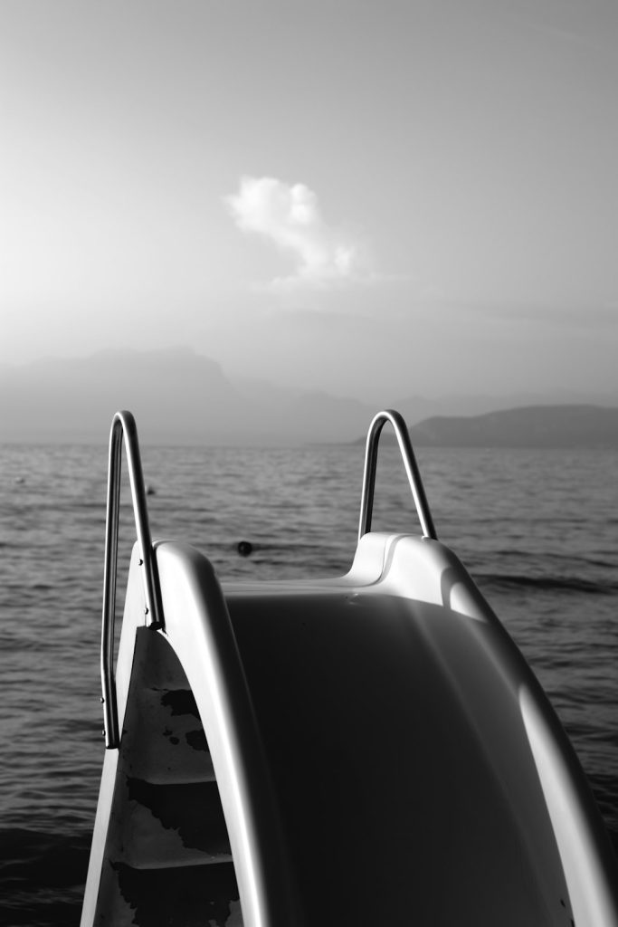 grayscale-photo-of-boat-on-sea-jaywhstchku