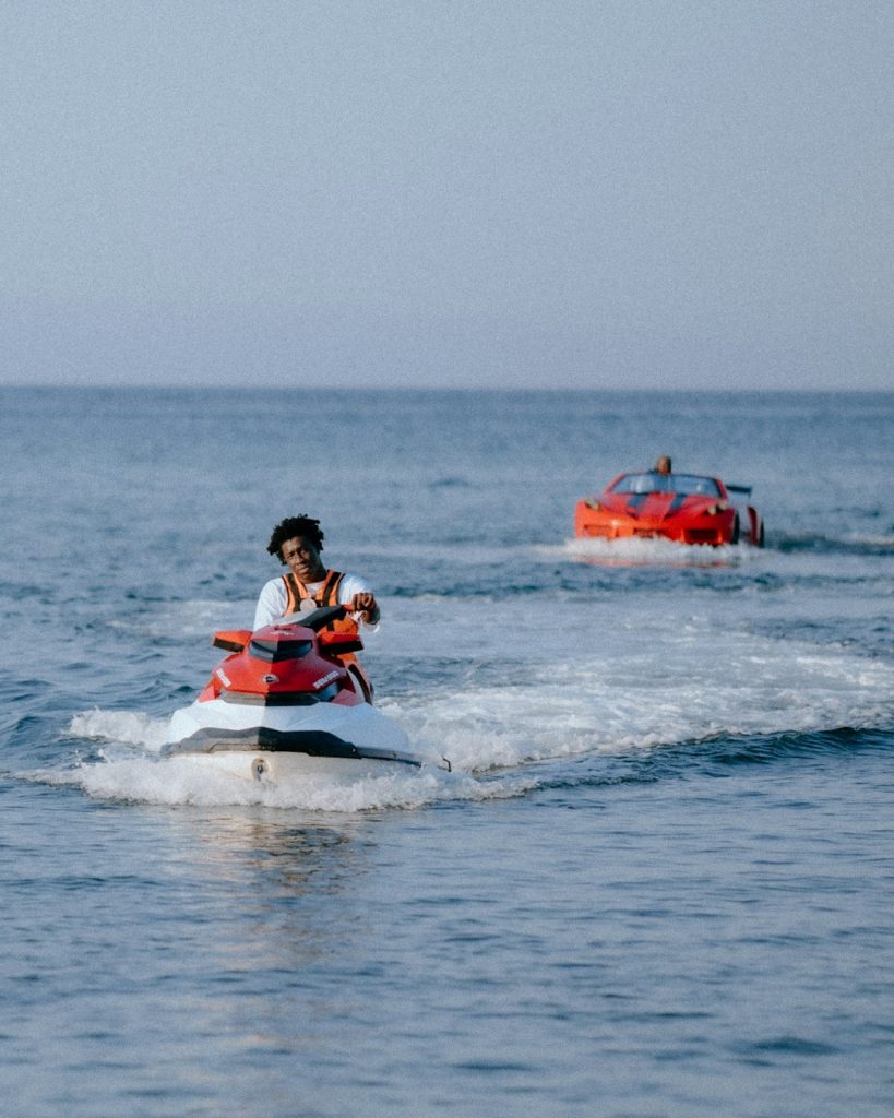 Crafting Captivating Headlines: Your awesome post title goes here man-riding-jet-ski-with-red-car-in-background-2odtyysljwg