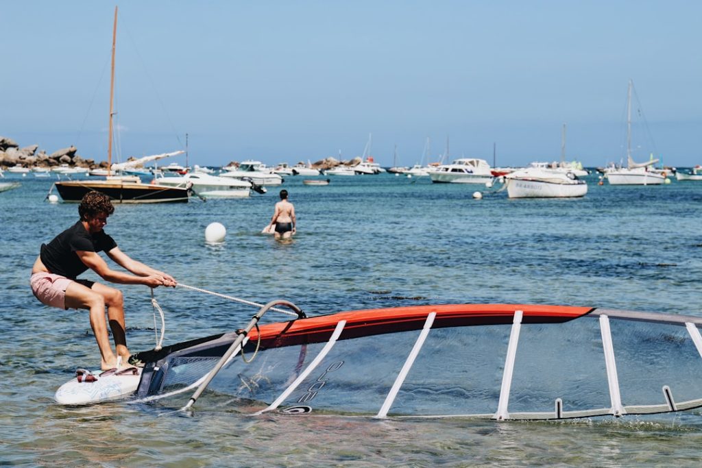people-riding-on-red-and-white-boat-on-sea-during-daytime-0yfmbkcqld4